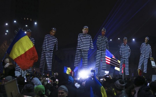 Protesters hold effigies with the faces of leader of Romania's leftist Social Democrat Party (PSD) Dragnea and other members of the party dressed as prisoners, during a demonstration in Bucharest